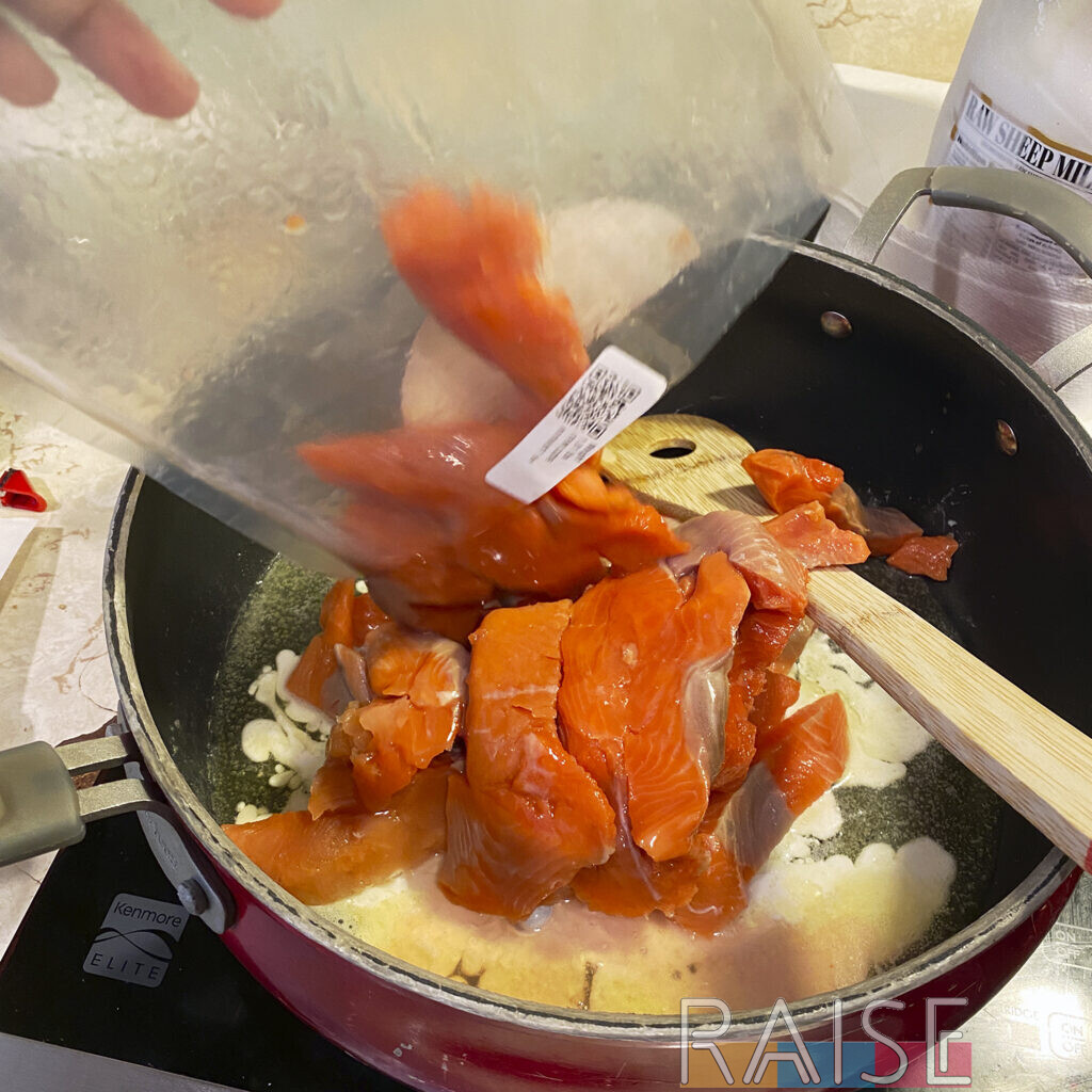 Adding Salmon to Pan by The Allergy Chef