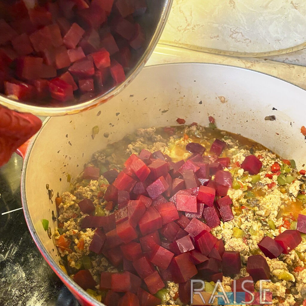 Adding Steamed Beets to Dutch Oven by The Allergy Chef