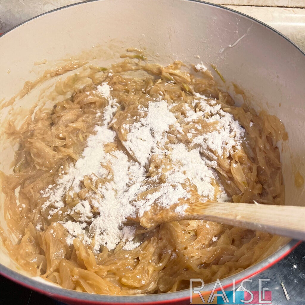 Gluten Free Flour Added to Onions in Dutch Oven by The Allergy Chef