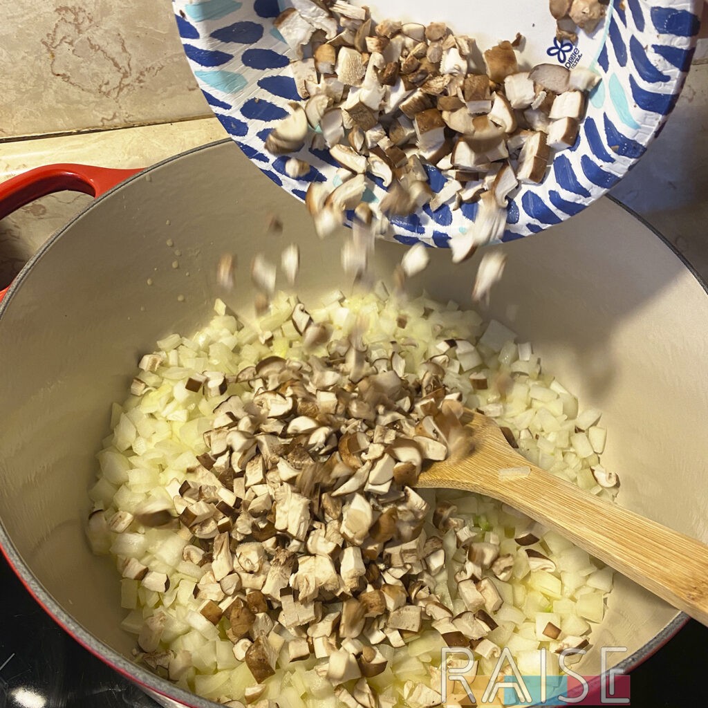 Adding Chopped Mushrooms to the Dutch Oven by The Allergy Chef