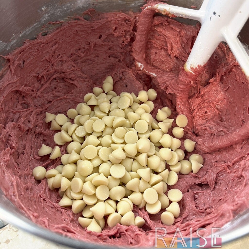 Organic Dairy Free White Chocolate Chips Added to Mixing Bowl by The Allergy Chef
