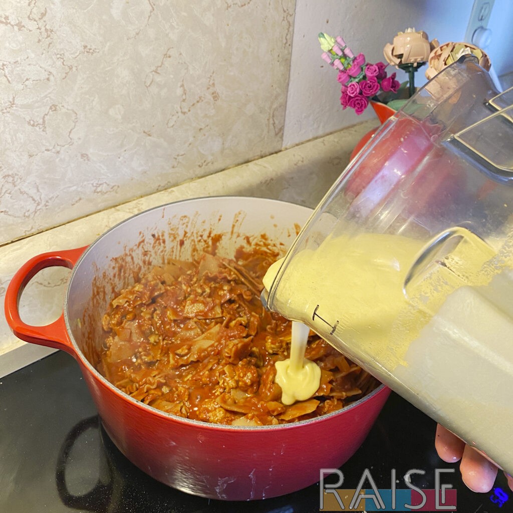 Pouring Squash Sauce Into Dutch Oven by The Allergy Chef